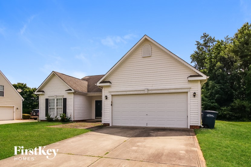 A two-story house with a garage is for sale.