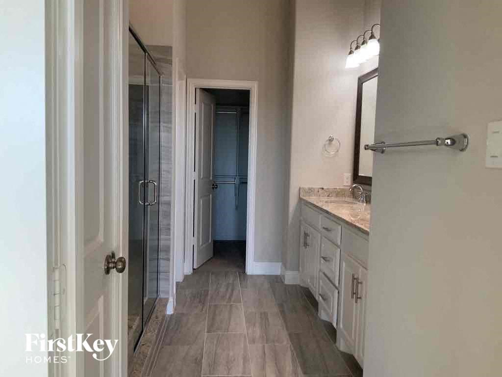 A bathroom with a walk-in shower and a toilet.