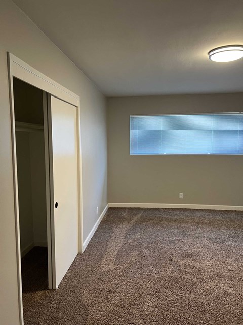 a empty room with a door and a window