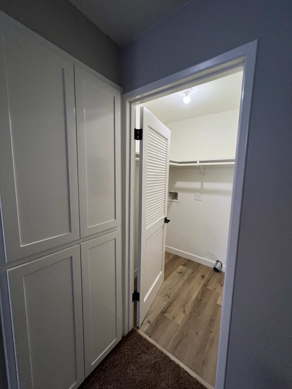 a bedroom with a closet and a door open to a bathroom