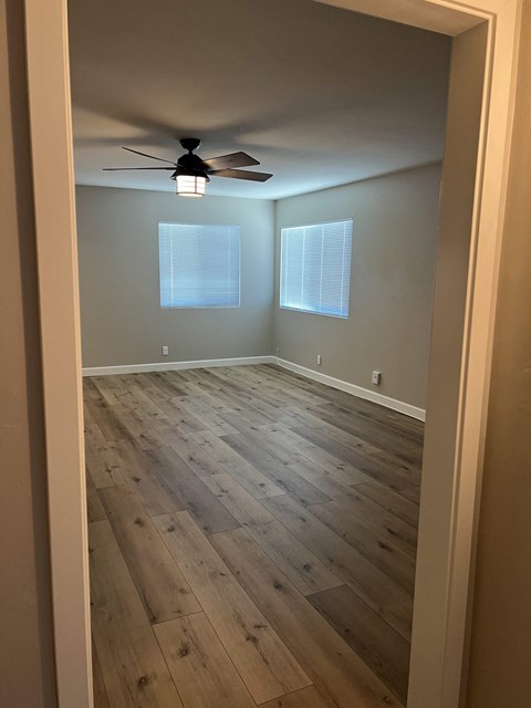 a room with hardwood floors and a ceiling fan