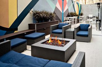 a seating area with chairs and a fire pit