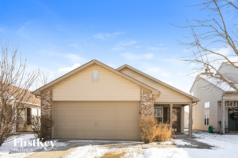 a garage door in front of a house in the snow