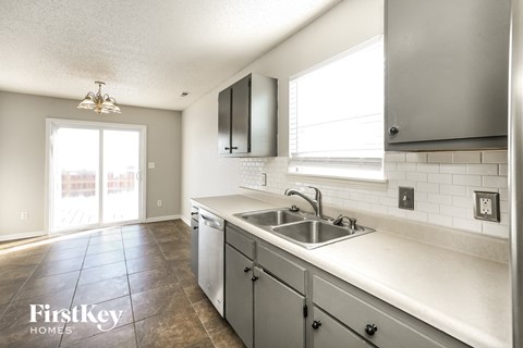 an empty kitchen with a sink and a window
