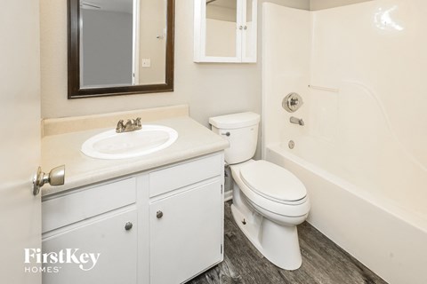 a bathroom with a sink toilet and a bath tub