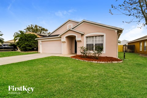 a home with a lawn and a sidewalk