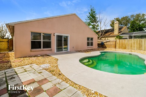 a backyard with a pool and a house