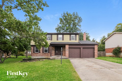 a brick house with a garage and a driveway