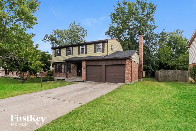 a brick house with a garage and a driveway