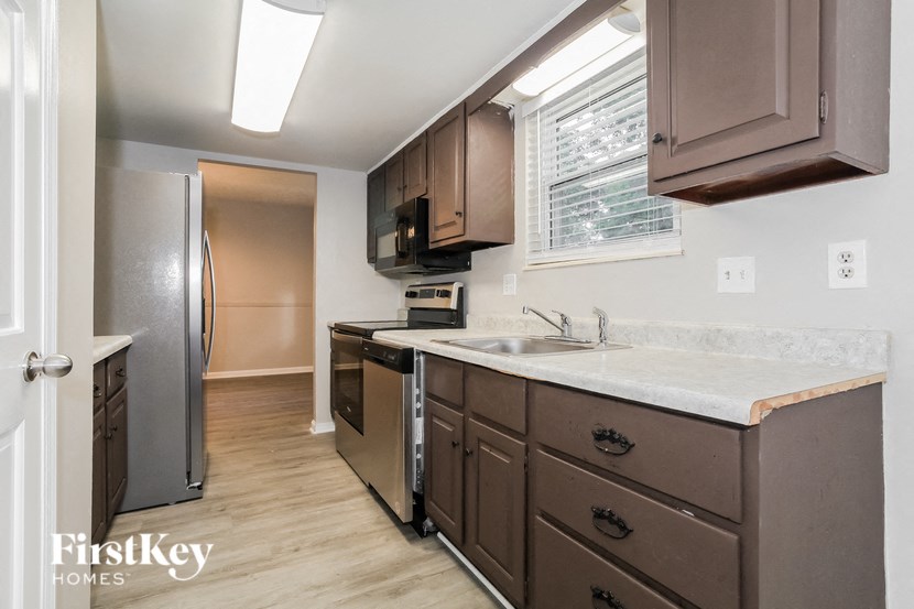 a kitchen with a sink and a refrigerator
