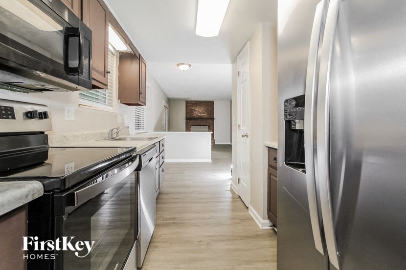 a kitchen with stainless steel appliances and white cabinets