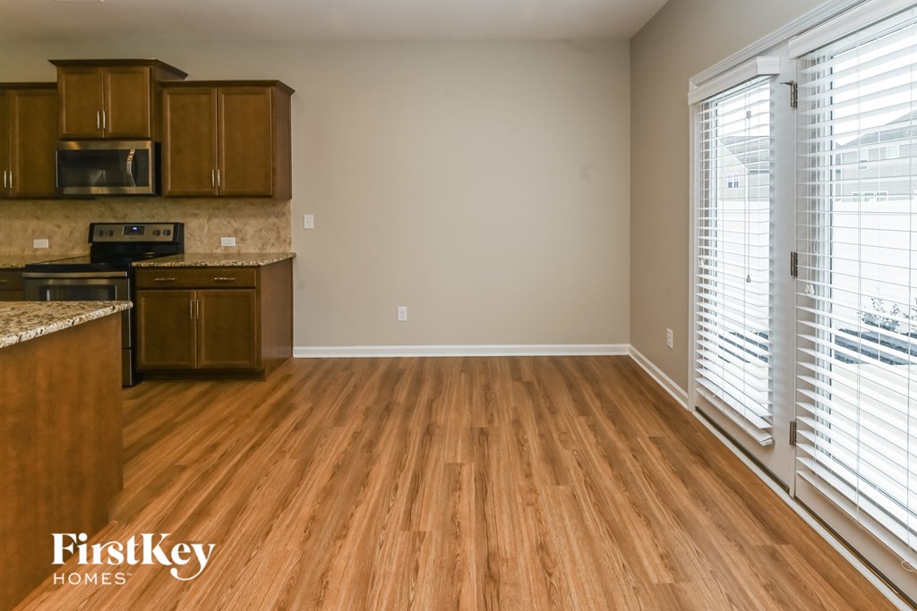 A kitchen with wooden floors and a FirstKey Homes logo.