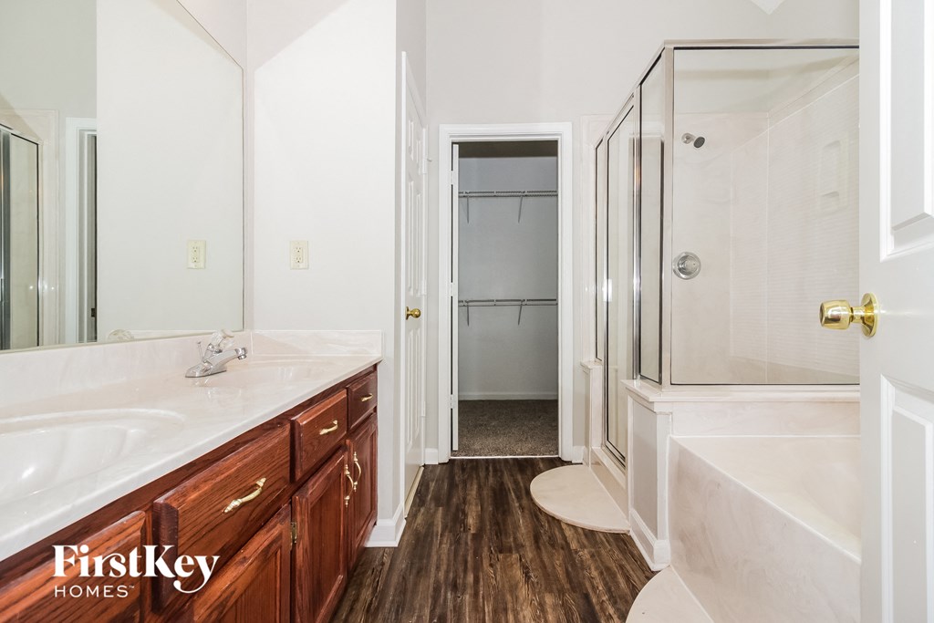 A bathroom with a white sink and a white tub.