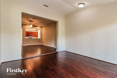 the living room and dining room with hardwood flooring