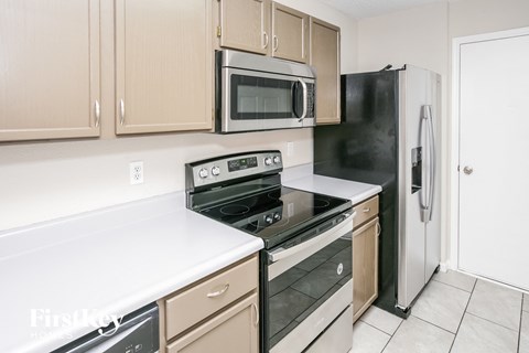 a kitchen with a stove microwave and refrigerator