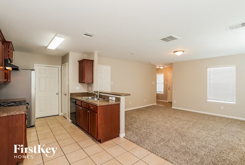 A kitchen with a brown counter top and a white door.