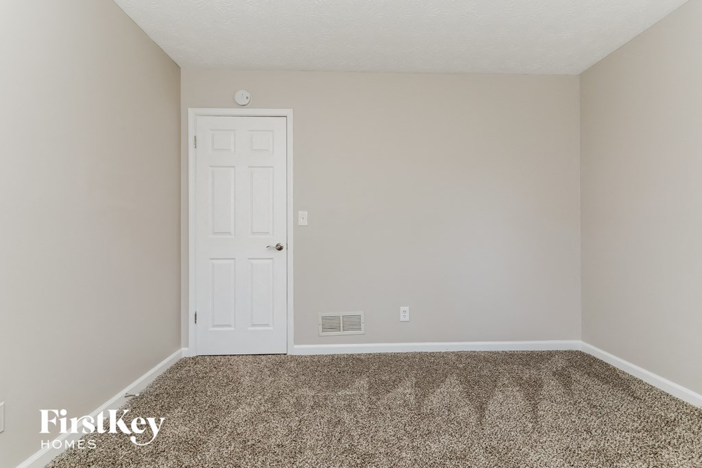 a room with carpet and a white door