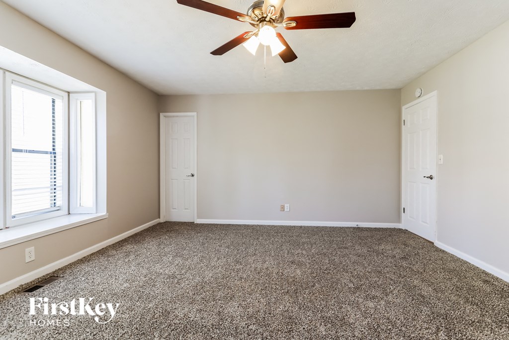 the master bedroom is spacious and has a ceiling fan