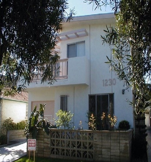 a white house with a fence in front of it