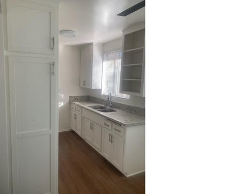 a kitchen with white cabinets and a sink