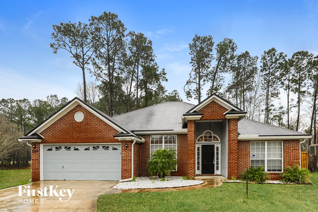 front view of a brick house with a white garage door