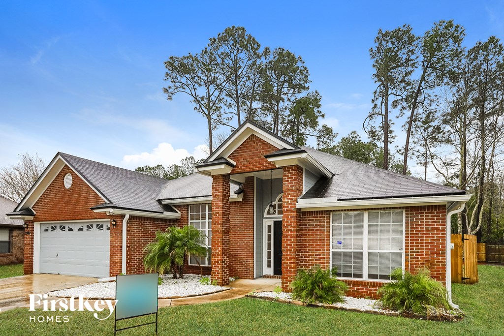 a red brick house with a white garage door