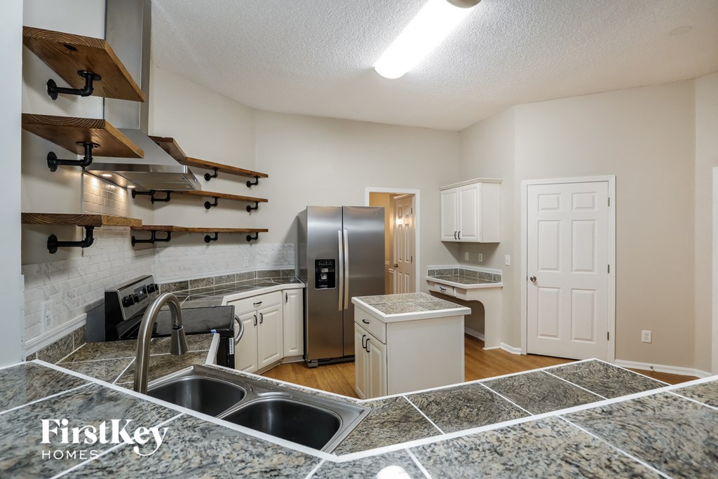 a kitchen with stainless steel appliances and granite counter tops