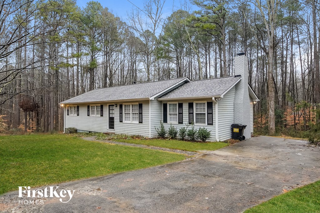 a small white house on the side of a road