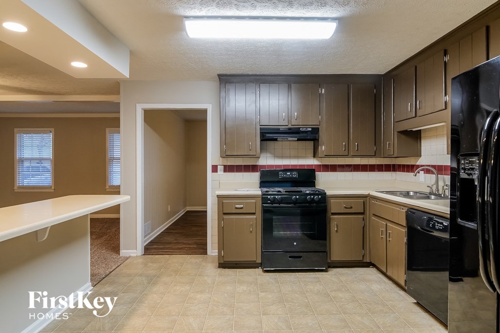 a kitchen with black appliances and wooden cabinets