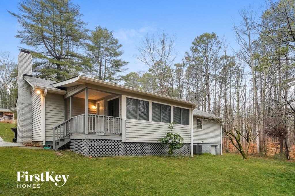 a white house with a porch on a hill