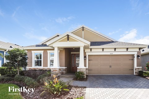 a house with a garage door and a driveway