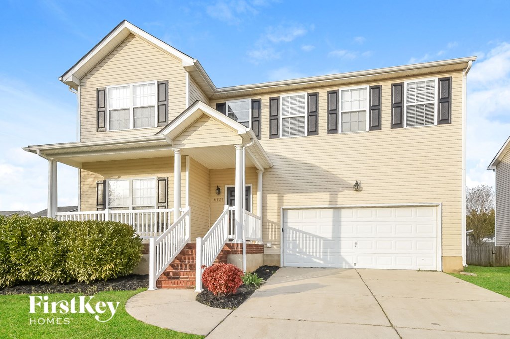 a yellow house with a white garage door