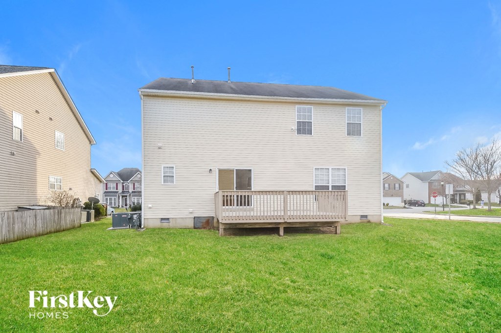 a white house with a porch and a grassy yard
