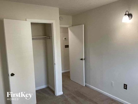 a bedroom with a closet and a hallway with two doors