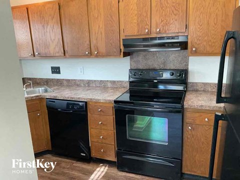 a kitchen with black appliances and wooden cabinets