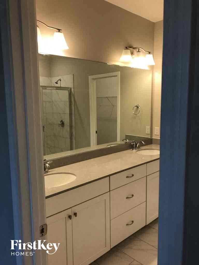 a bathroom with two sinks and a mirror