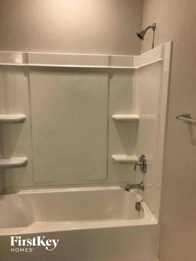 a bathroom with a shower and a bath tub