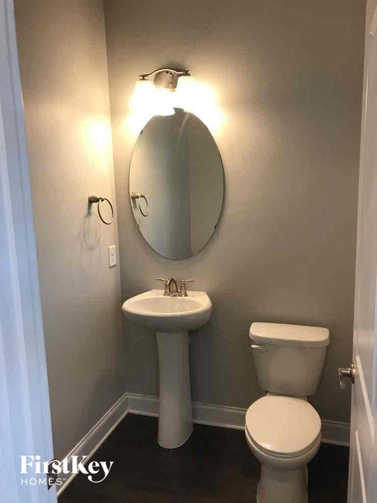 a small bathroom with a toilet sink and mirror