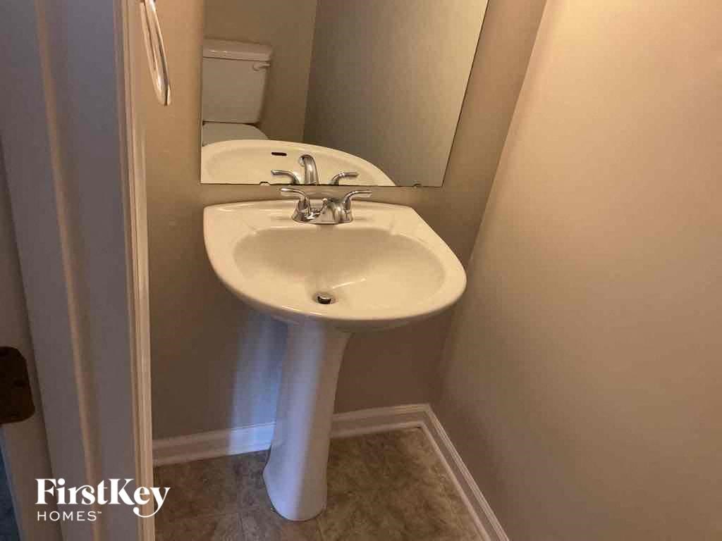 a small bathroom with a sink and a mirror