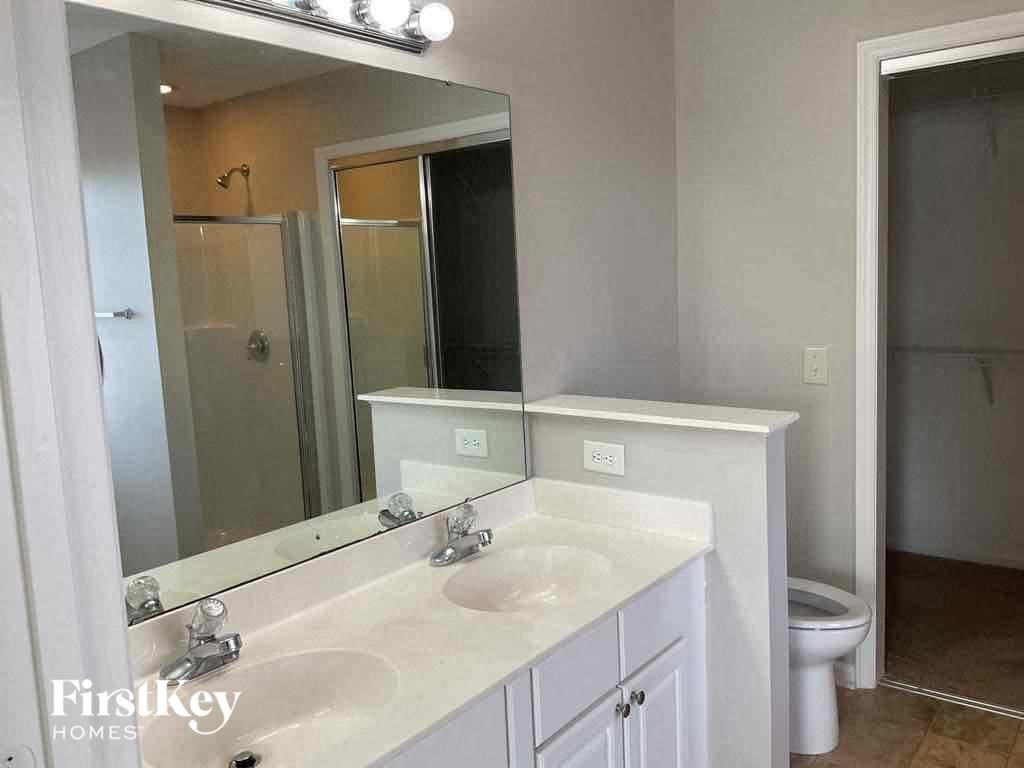a bathroom with a sink and a mirror and a toilet