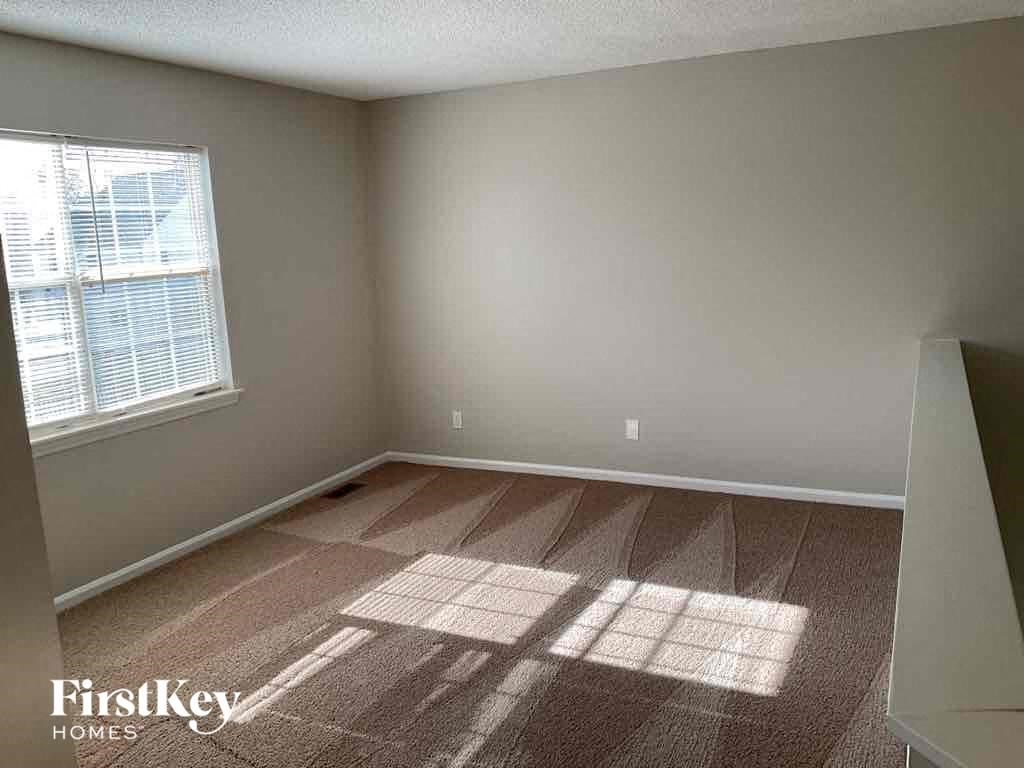an empty room in a home with a window