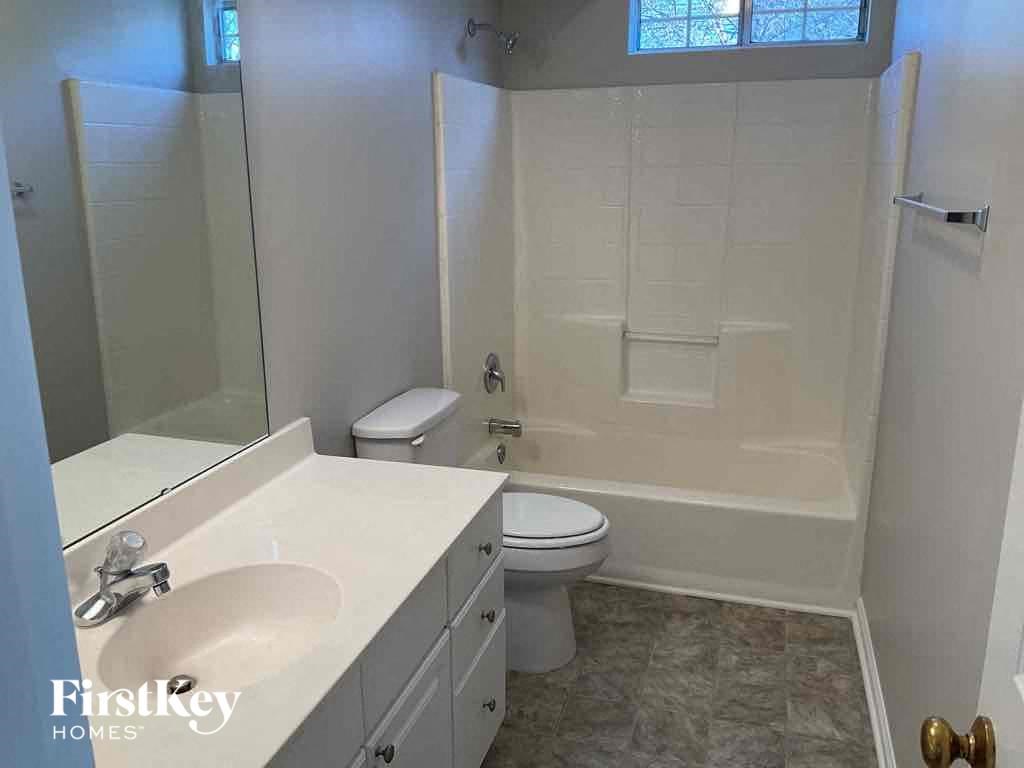 a white bathroom with a sink toilet and tub