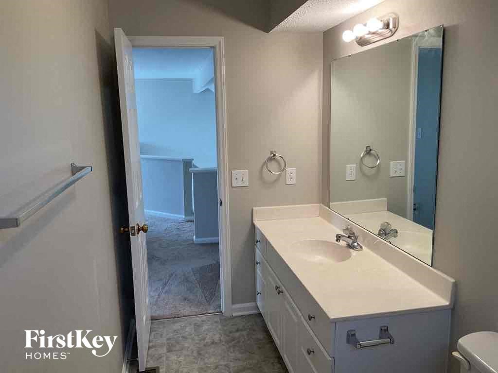 a bathroom with a sink and a mirror and a toilet