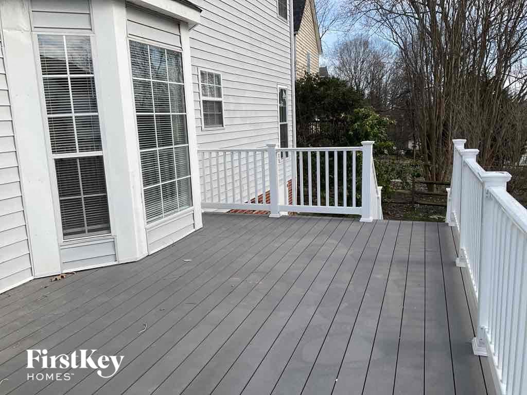a white deck in front of a white house