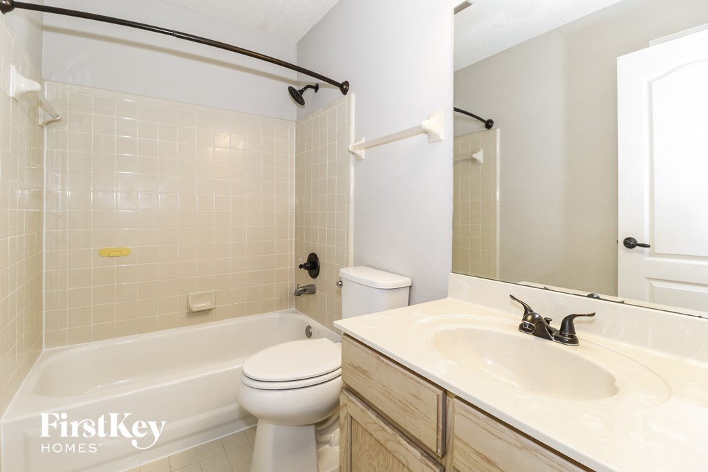 a bathroom with a sink and a toilet and a bath tub