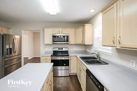 A kitchen with wooden cabinets and stainless steel appliances.