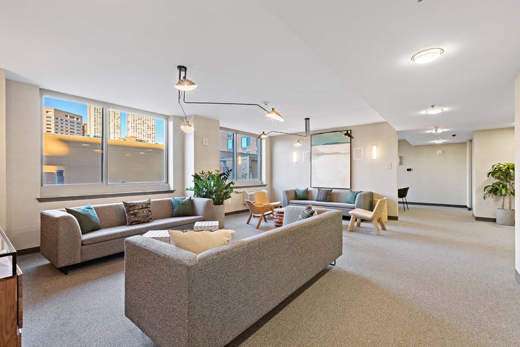 a large living room with couches and chairs