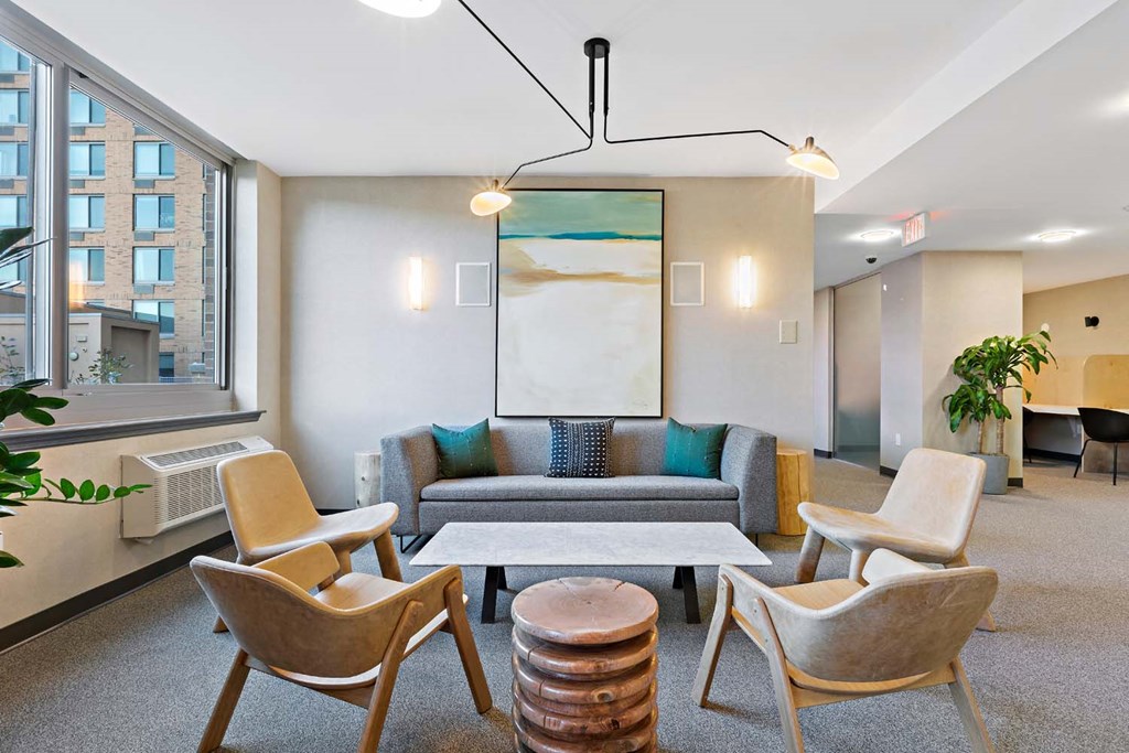 a living room with a couch and chairs and a table