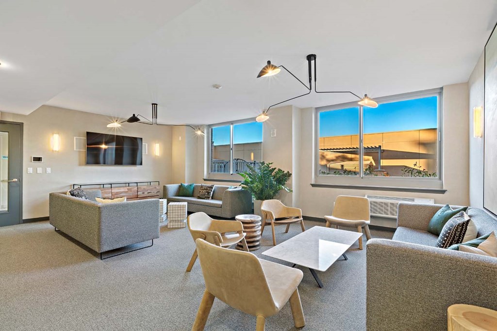 a living room filled with furniture and a large window