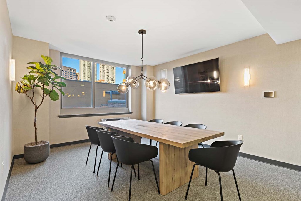a dining room with a wooden table and black chairs
